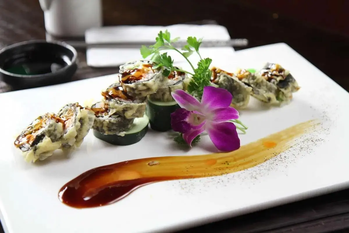 Oriental-Palace-Chinese-Restaurant-City-Roll-Castaic Tempura sushi roll with drizzled sauce, garnished with orchid, at Oriental Palace, a Asian Restaurant in Lawnside