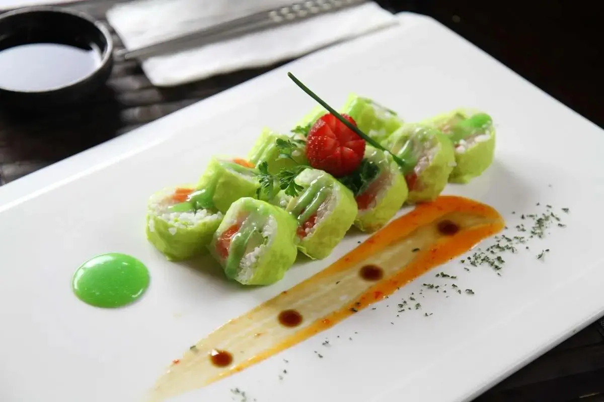 Oriental-Palace-Chinese-Restaurant-Incredible-Hulk-Roll-Castaic Green sushi roll with strawberry garnish and colorful sauce, at Oriental Palace, a Asian Restaurant in Lawnside