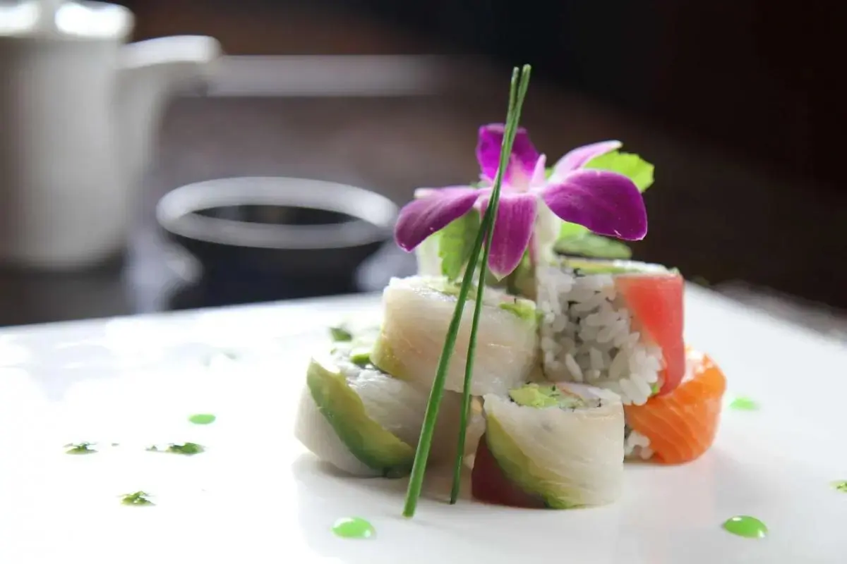 Oriental-Palace-Chinese-Restaurant-Rainbow-Roll-Castaic Assorted sushi roll with orchid and green garnish, at Oriental Palace, a Asian Restaurant in Lawnside